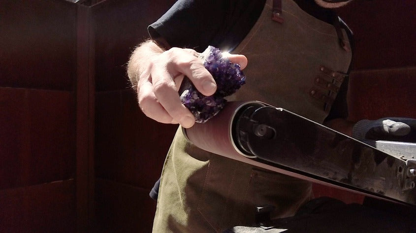 Sanding amethyst crystal before gold plating